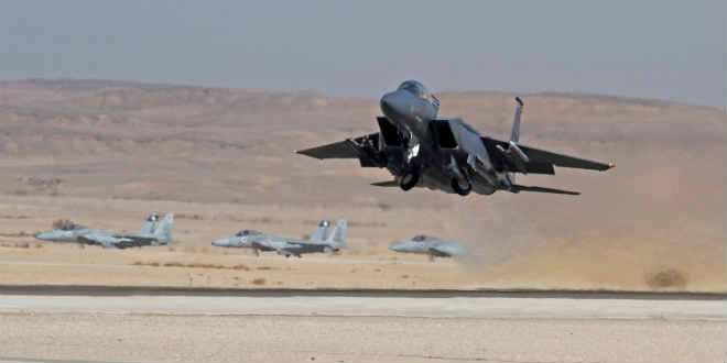 USAF F-15E takes off with Israeli F-15's waiting for a take off in the background at the Ovda airbase in Israel as part of the most recent joint exercise. (Photo: Ofer Zidon/Flash90)