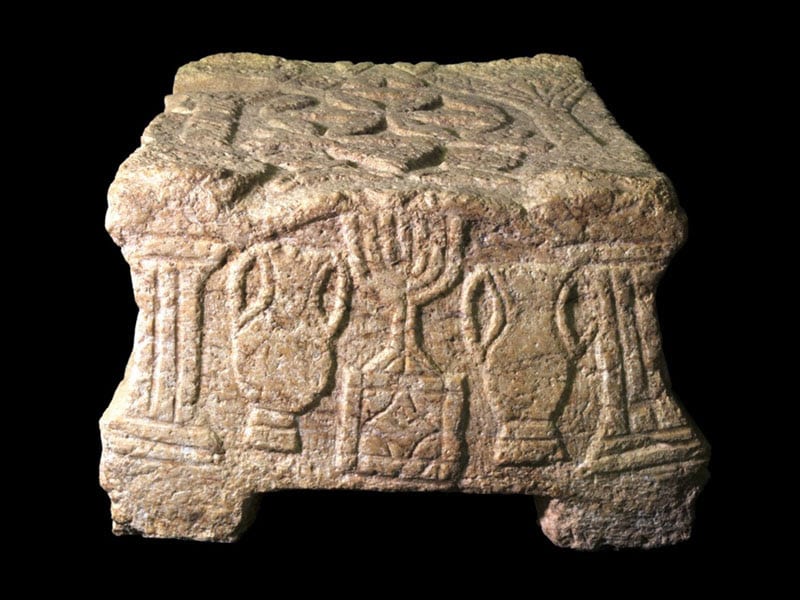 The stone with the menorah symbol which was discovered in the synagogue at Magdala. (Photo: Yael Yulowich, courtesy of the Israel Antiquities Authority/MFA)