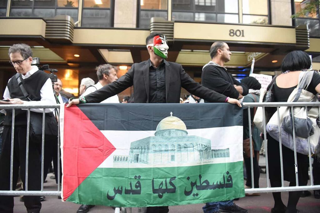 Flags held at a prior “Day of Rage” attended by Students for Justice in Palestine and other anti-Israel organizations. Credit: A Katz/Shutterstock.